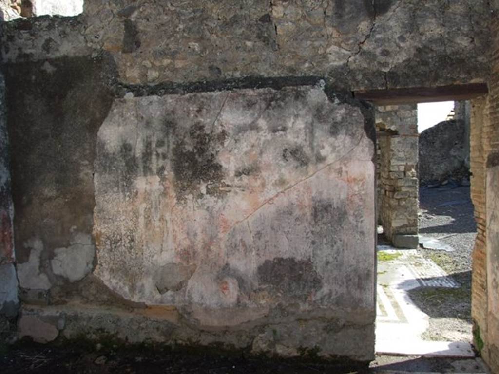 VI.8.20 Pompeii. March 2009. Room 5, south wall with bed recess, in alcove on left (east), and doorway to room 6. 
According to PPM – the middle zone of the wall in the antecamera would have had red panels, with a yellow panel in the alcove.  
 
