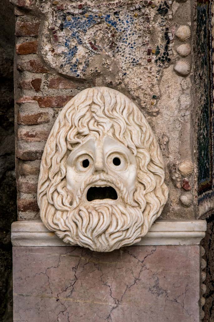 VI.8.22 Pompeii. January 2019. 
Hollow marble mask on south side of fountain. Photo courtesy of Johannes Eber.
