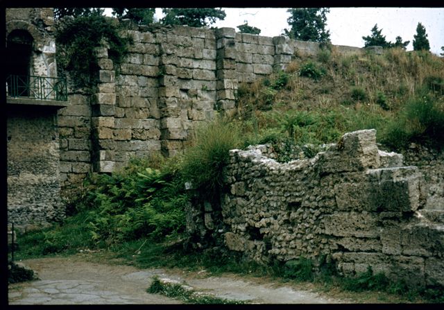 VI.9.1 Pompeii.    North west corner of exterior front wall on Via Mercurio, with Tower XI and City Walls.  Photographed 1970-79 by Günther Einhorn, picture courtesy of his son Ralf Einhorn.
