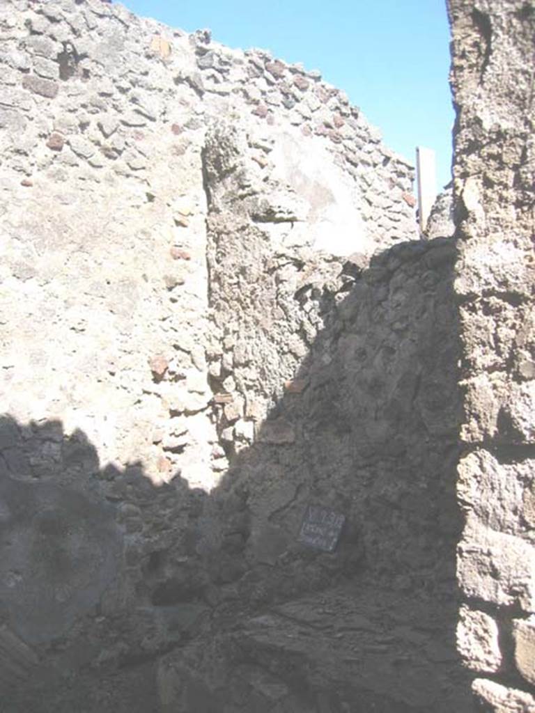 VI.9.12 Pompeii. July 2008. Latrine and downpipe on south side of entrance doorway. Photo courtesy of Barry Hobson.