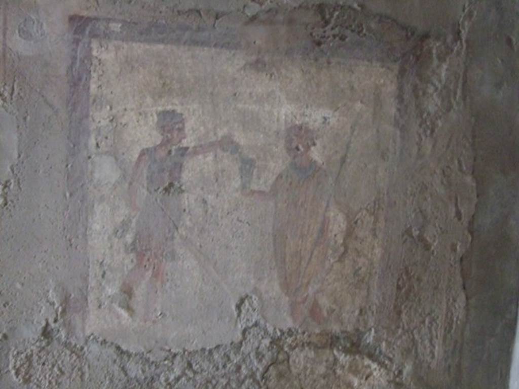 VI.10.1 Pompeii. March 2009. Fresco on north wall of rear room on north side.  A soldier with spear in his left hand holds out his cup to a slave.  
“Da fridam pusillum” (CIL IV 1291) has been inscribed on the picture.
According to Cooley, this graffiti has been written above the people’s head, as if they are speaking. She says this showed a soldier being served wine by a slave and he was saying “Give a drop of cold”. See Cooley, A. and M.G.L., 2004. Pompeii : A Sourcebook. London : Routledge. (p.162, CIL IV 1291)


