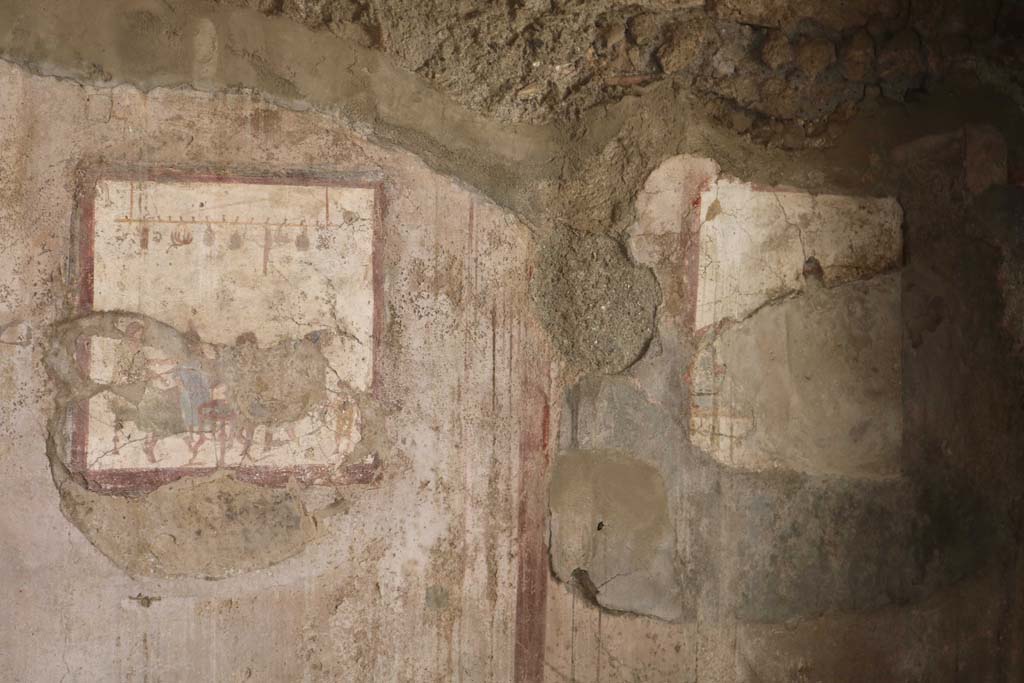 VI.10.1 Pompeii. December 2018. Two frescoes at west end of south wall of rear room. Photo courtesy of Aude Durand.