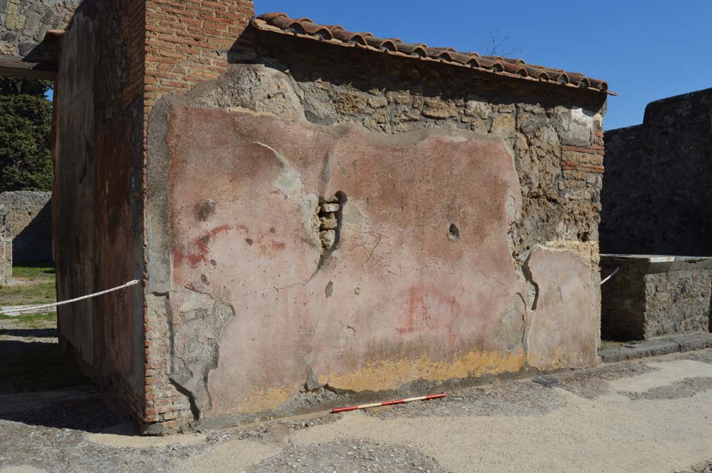 VI.10.2 Pompeii, on left. December 2018. 
Looking east on Via di Mercurio towards front facade with painted plaster, with VI.10.3, on right. Photo courtesy of Aude Durand.
