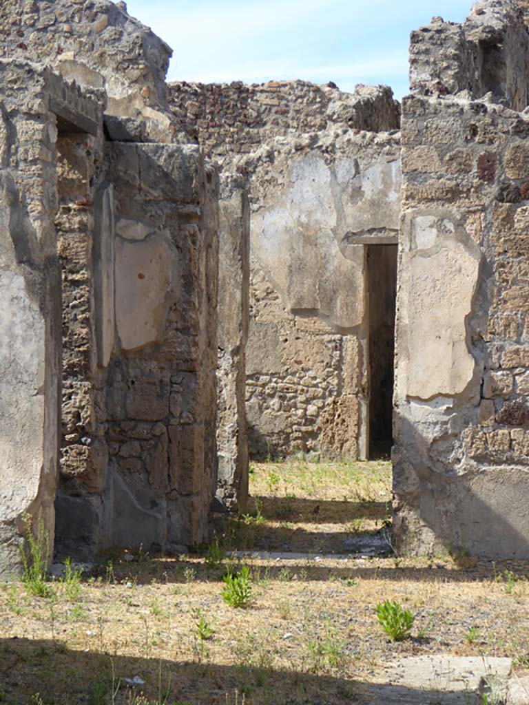 VI.11.9 Pompeii. November 2017. 
Looking north in north-west corner of atrium 3, with doorway to room 8, on left.
In the centre is the doorway into the corridor 15 at the base of the stairs 9.

