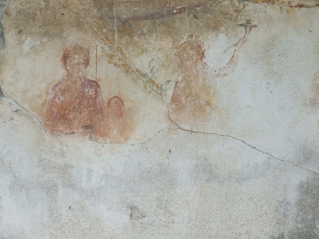 VI.11.9 Pompeii. December 2006. 
Room 16. Household lararium showing Venus Pompeiana, Amor or Eros, and a Lar. A garland can be seen above.

