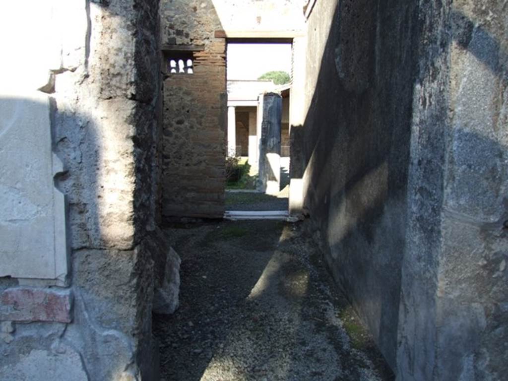 VI.11.10 Pompeii. December 2007. Room 34, room or corridor leading north from atrium to peristyle.
In the north-west corner can be seen a small window, which was closed by a plaque of terracotta pierced by six small arched openings.
They resembled the entrances into a dove-cote. Many of this type had been found at Pompeii.
See Breton, Ernest. 1870. Pompeia, Guide de visite a Pompei, 3rd ed. Paris, Guerin. 

