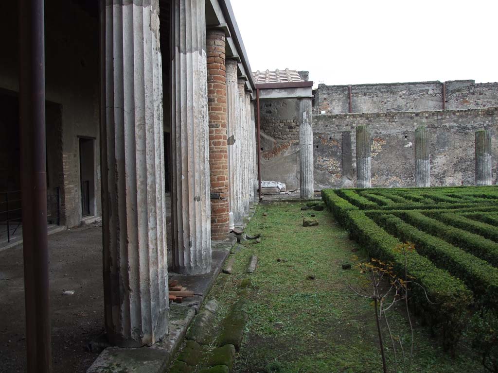 VI.11.10 Pompeii. December 2006. Peristyle 36, looking east along north side of the peristyle.
According to Garcia y Garcia –
the same bomb that fell on the house to the north of this house, also caused the partial disintegration of the roof of the stately rooms on the north side of this peristyle.
See Garcia y Garcia, L., 2006. Danni di guerra a Pompei. Rome: L’Erma di Bretschneider, (p.82).
