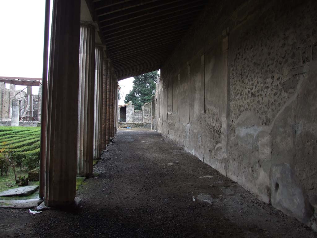 VI.11.10 Pompeii. December 2006. Looking south along west portico, from north-west corner of Peristyle 36.