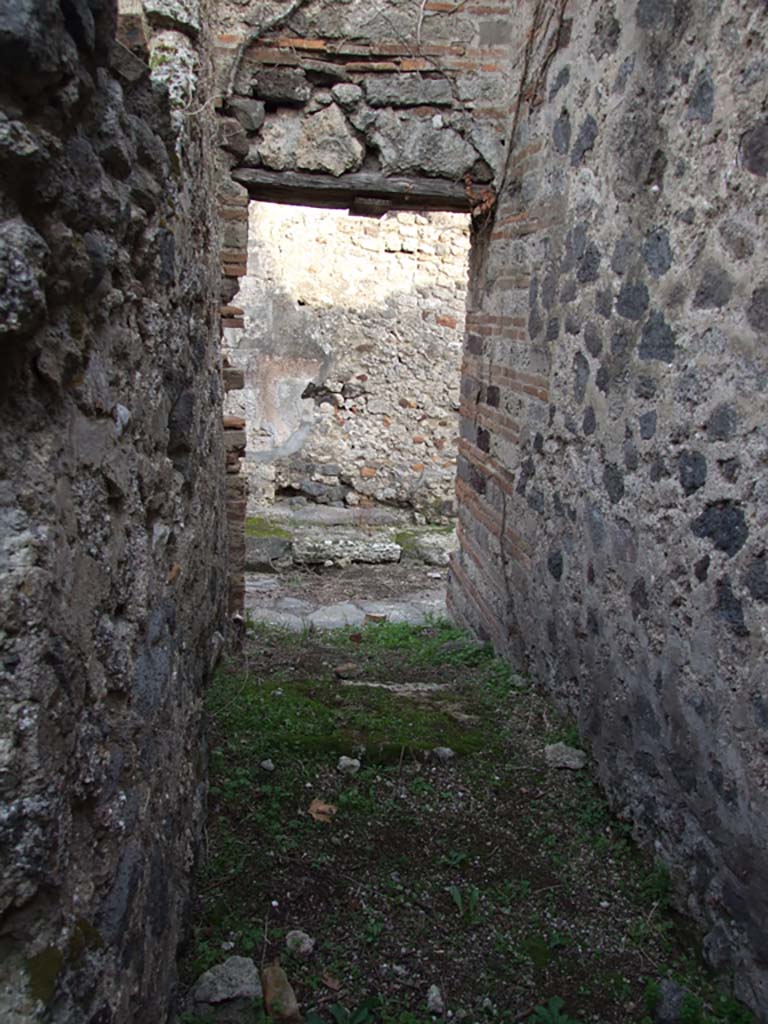 VI.11.18 Pompeii. September 2005. Back entrance doorway to yard, with steps to upper floor.  
