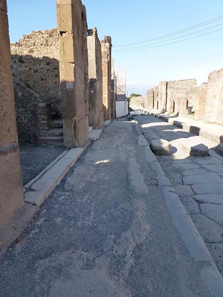VI.12.4 Pompeii. June 2012. Looking east along pavement on north side of Via della Fortuna, looking east. Photo courtesy of Michael Binns.
