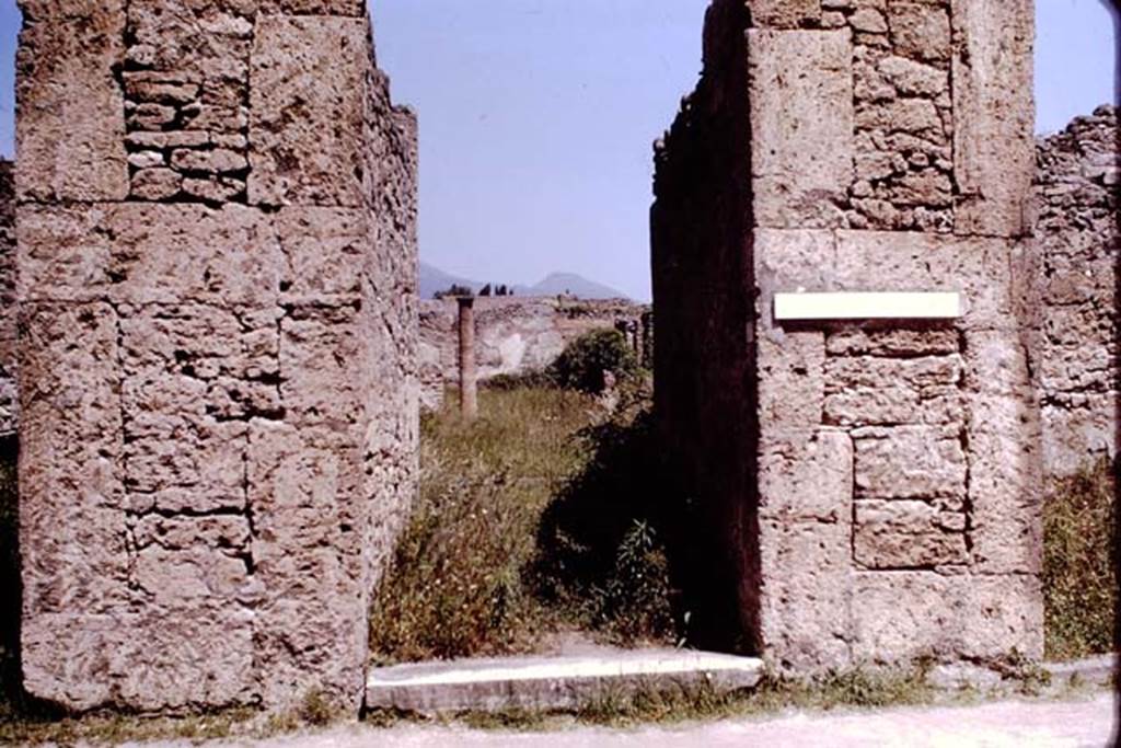 VI.13.6 Pompeii. December 2004. Entrance doorway. According to Pagano and Prisciandaro, found in April 1841 were recommendations on the exterior walls of VI.13.6-9. They read –
Fuscum aed(ilem)
Iphigenia facit    [CIL IV 457]
Vicini
cum Capitone
rog(ant)    [CIL IV 458]
R]ustium aed(ilem)
rogamus dignus est    [CIL IV 459]
Paquium et Caprasium
probissimos d(uum)v(iros) i(ure) d(icundo) o(ro) v(os) f(aciatis)    [CIL IV 460]
M(arcum) Samellium Modestum aed(ilem)
d(ignum) r(ei) p(ublicae) o(ro) v(os) f(aciatis)    [CIL IV 465]
See Pagano, M. and Prisciandaro, R., 2006. Studio sulle provenienze degli oggetti rinvenuti negli scavi borbonici del regno di Napoli.  Naples : Nicola Longobardi. (p.157)  PAH II, 395; III, 169.
