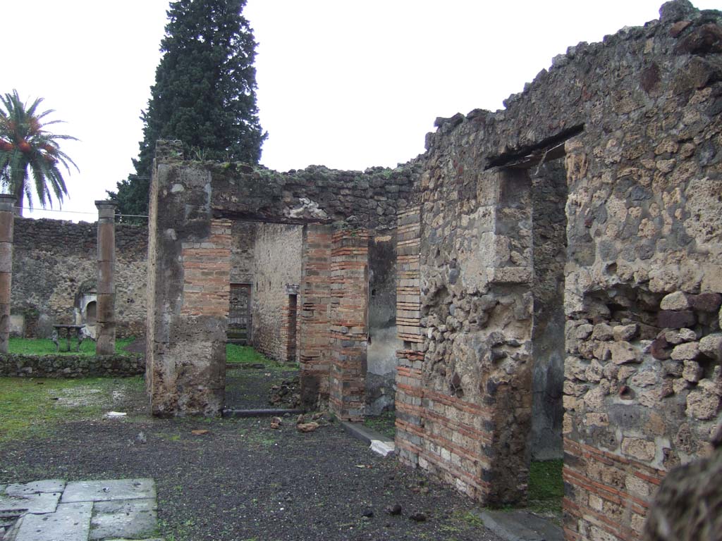 VI.13.13 Pompeii. December 2005. Doorways to rooms on north side of atrium.
On the left, the tablinum, then doorway to oecus with corridor to rear, the north ala, and cubiculum on the right.
