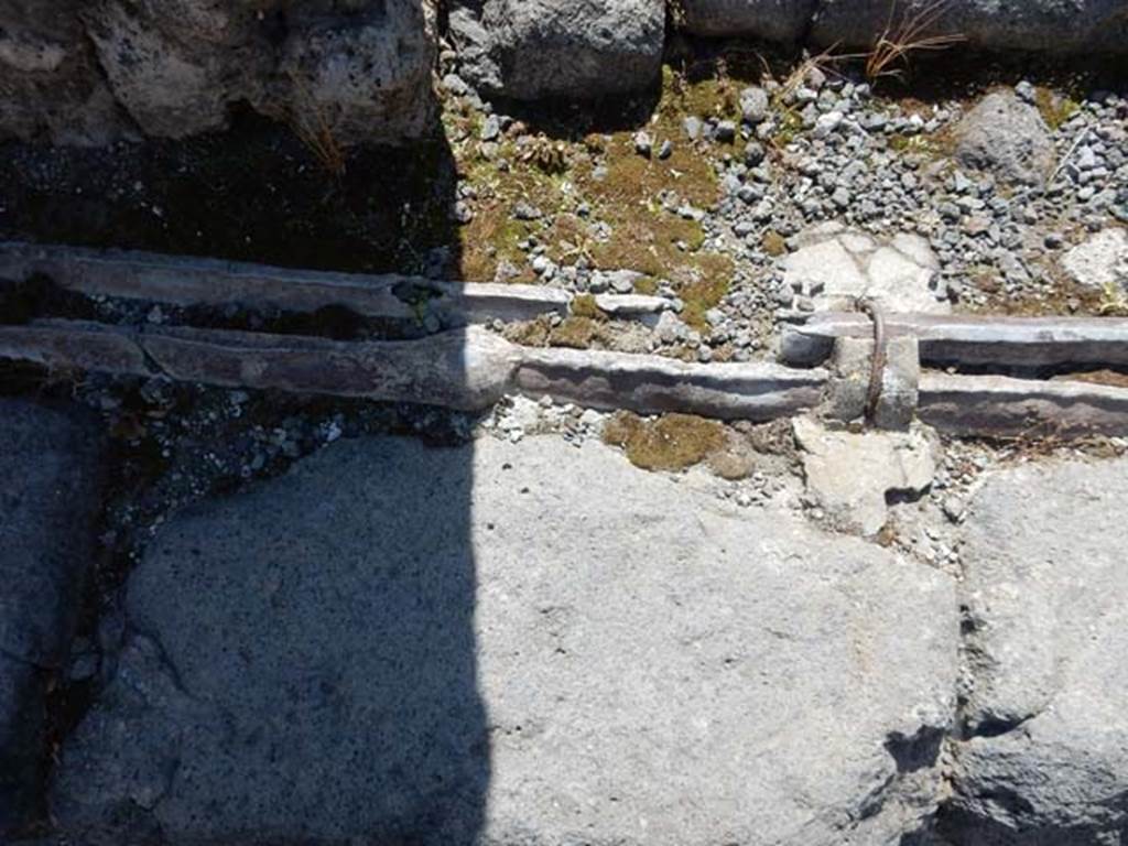 VI.13.14 Pompeii. May 2015. Detail of lead pipes in pavement. Photo courtesy of Buzz Ferebee.
