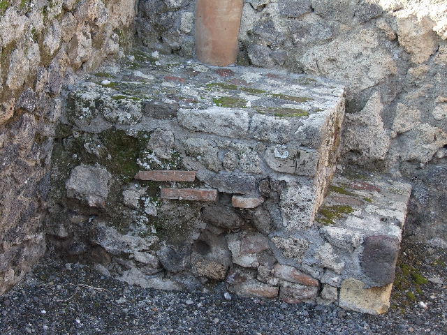VI.14.4 Pompeii. December 2006. Masonry base of steps to upper floor, with down-pipe behind.