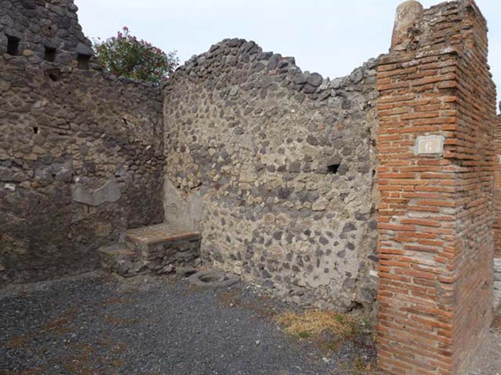 VI.14.6 Pompeii. September 2011. East wall of shop, and cistern mouth. Photo courtesy of Michael Binns.
