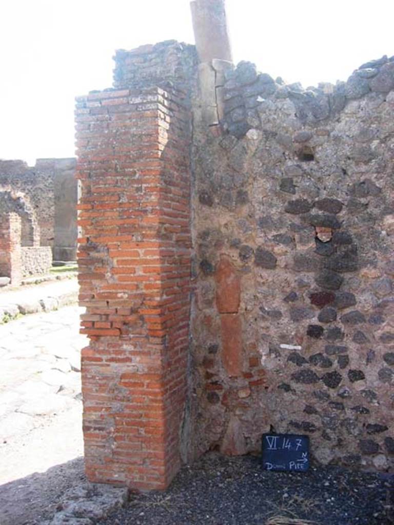 VI.14.7 Pompeii. July 2008. South-west corner of shop, with downpipe. Photo courtesy of Barry Hobson.