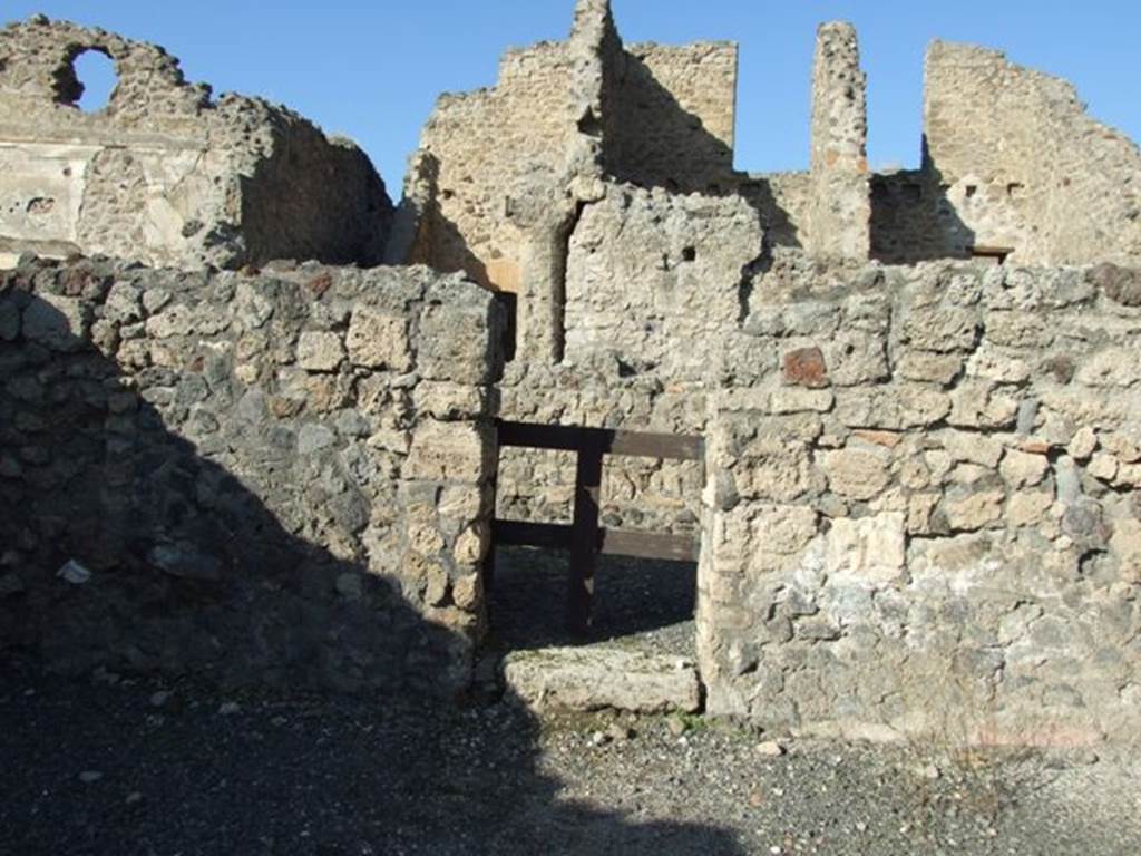 VI.14.15 Pompeii. December 2007. North wall of shop, with doorway to rear room.
