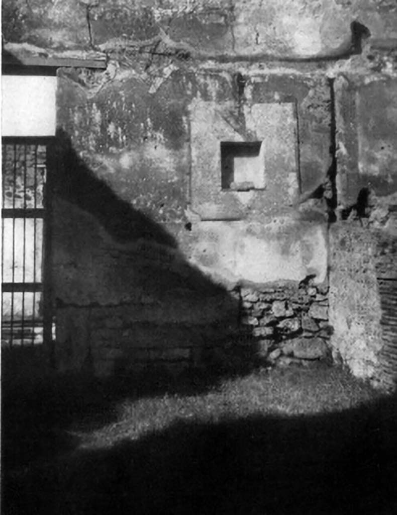 VI.14.18 Pompeii. 1930s photo of lararium niche by Tatiana Warscher.
According to Boyce, in the north wall of the main room (of VI.14.18/19) is a rectangular niche, set 2.10 m above the floor.
It is set in a section of the wall coated with a special panel of white stucco bordered with red stripes.
The inside walls are coated with the same white stucco.
The floor of the niche projects slightly from the surface of the wall.
In the centre of it is set a masonry block to serve either as a base for a statuette or as an altar.
See Boyce G. K., 1937. Corpus of the Lararia of Pompeii. Rome: MAAR 14. (p.52, no.199, with Pl.1, 2) 
