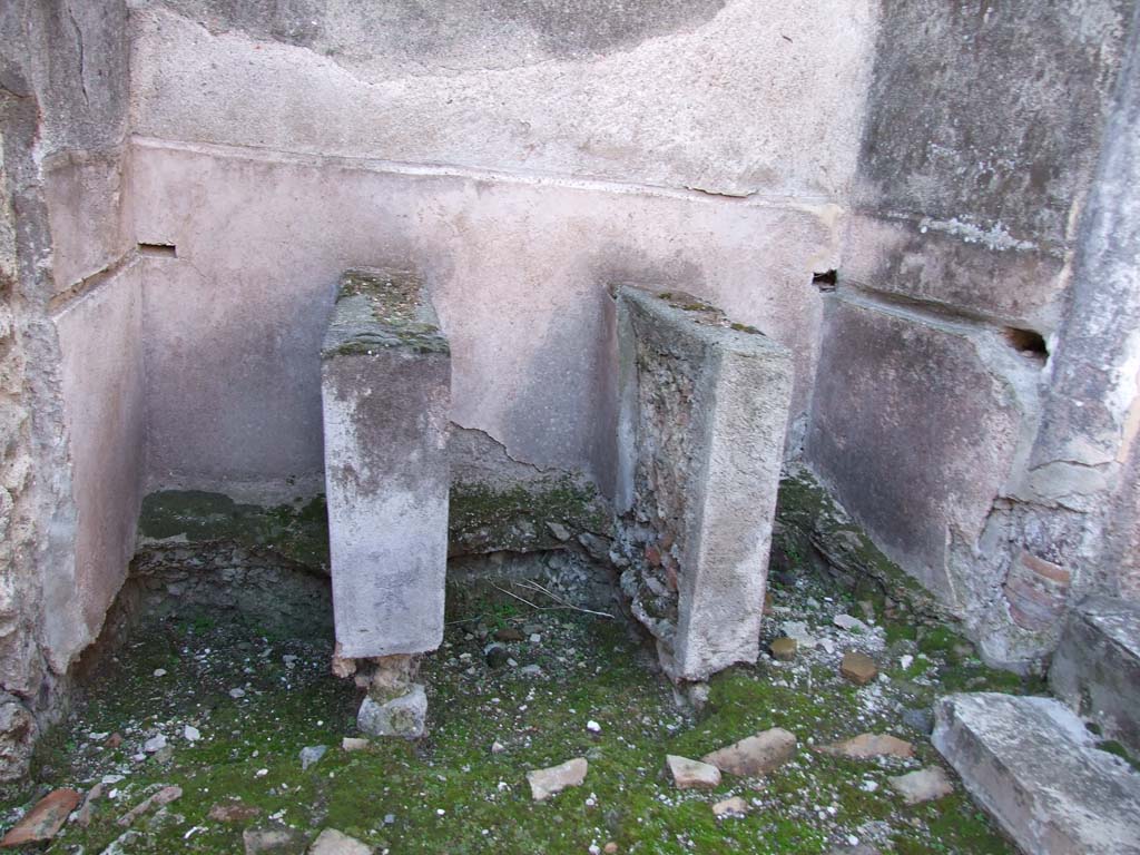 VI.14.22 Pompeii. December 2007. Room 12, three basins.
According to Seyffert, clothes when sent to be cleaned were stamped with the feet in pits or troughs filled with warm water and substances which separated the fat from them, as urine, nitre, and fuller's earth. If the object was to felt the web, and make it thicker and stronger, the same process was gone through, and the cloth was then beaten with rods, washed out in clean water, dried, carded with a kind of thistle or with the skin of a hedgehog, fumigated with sulphur, rubbed in with fuller's earth to make it whiter and stronger, and finally dressed by brushing, shearing, and pressing. The fuller's earth, when well rubbed in, pre¬vented the clothes from getting dirty too soon, and freshened up the colours which the sulphur had destroyed. 
See Seyffert, Dr O., 1894, Dictionary of Classical Antiquities, London: William Glaisher. (p.243-4).
