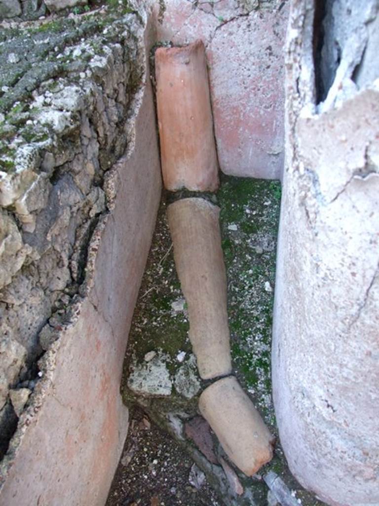 VI.14.22 Fullonica of Balbinus.  December 2007.  Room 12.  Terracotta and lead piping in north west corner of peristyle.