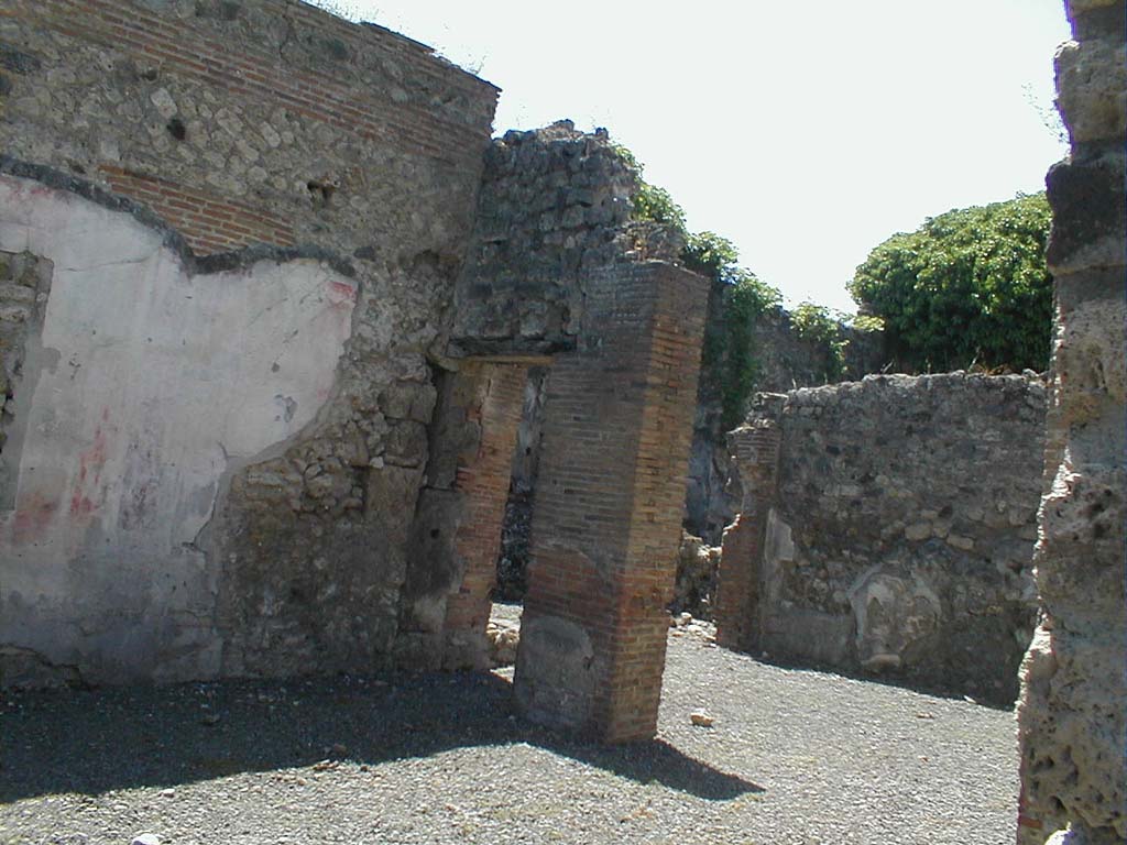 VI.14.30 Pompeii. May 2005. Looking towards south wall of atrium, and south-west towards the garden area, across the tablinum.
According to Jashemski, the small garden excavated in 1875, to the south of the tablinum had a roofed passageway on the north and west.
Built against the east wall was an aedicula lararium: on the south wall was a low niche, perhaps for decorative sculpture, and a garden painting.
There were two puteals, one of terracotta the other of lava.
See Jashemski, W. F., 1993. The Gardens of Pompeii, Volume II: Appendices. New York: Caratzas. (p.150)
