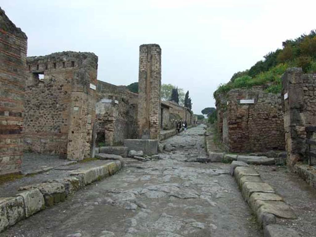 VI.14.31 Pompeii. May 2010. Looking north towards middle of Via Stabiana (Via del Vesuvio) at the north east corner of VI.14. Near here the cast of the woman with her tunic raised above her head and the supine man, were made.
