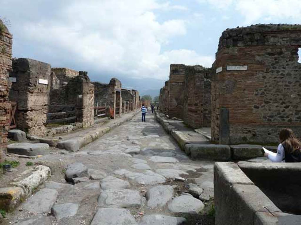 VI.14.31 Pompeii. May 2010. Looking south towards middle of Via Stabiana (Via del Vesuvio) with the north east corner of VI.14 on the right. Near here the cast of the woman with her tunic raised above her head and the supine man, were made.
