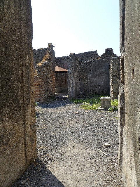 VI.14.34 Pompeii. December 2007. Looking south-east across atrium towards entrance to bakery with white threshold, doorway to garden-yard and doorway to tablinum, from entrance corridor.
