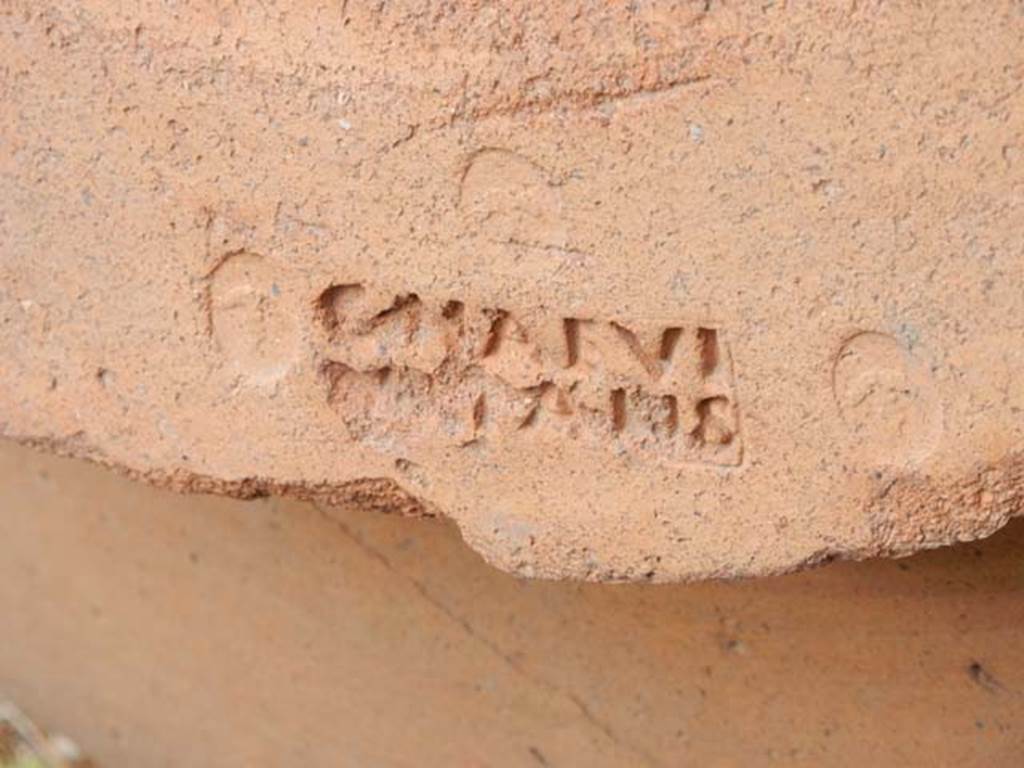 VI.14.35 Pompeii. May 2017. Detail of embossed stamp on large terracotta pot on east side of doorway.  Photo courtesy of Buzz Ferebee.
