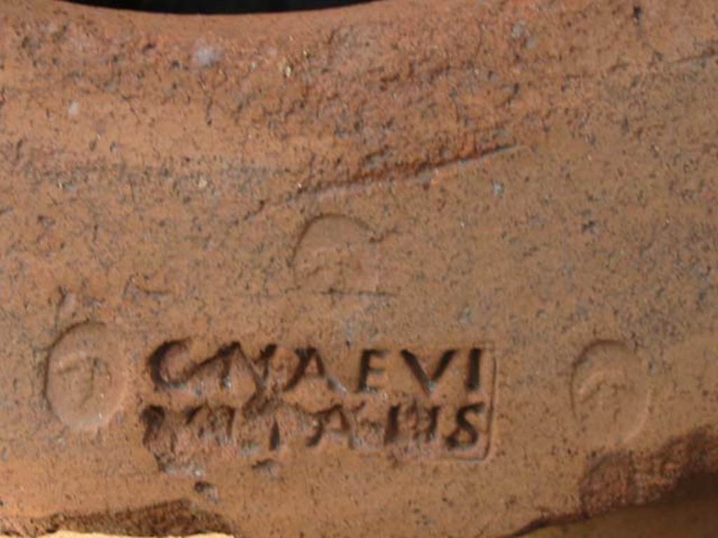 VI.14.35 Pompeii. May 2003. Embossed stamp C. NAEVI VITALIS in large terracotta pot on east side of doorway.  
Photo courtesy of Nicolas Monteix.
