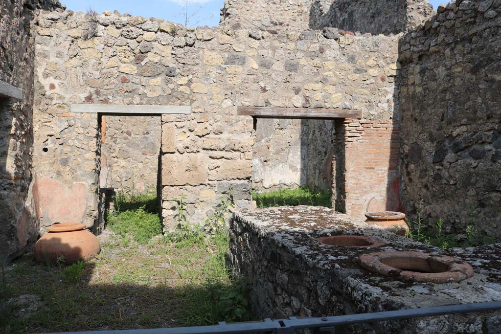 VI.14.36 Pompeii. December 2018. 
Looking west towards hearth against north wall near doorway to bar-room. Photo courtesy of Aude Durand.
