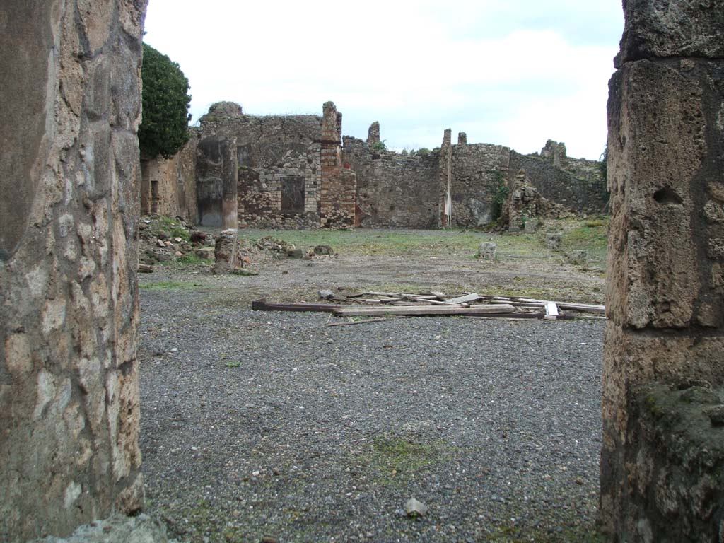 VI.14.38 Pompeii. December 2007. Looking east across atrium, tablinum and peristyle, from entrance doorway. According to Garcia y Garcia, this house was badly hit by the 1943 bombing. It caused the destruction of the atrium floor, including the impluvium and the marble table. Also destroyed were the two rooms nearby on the north side of the atrium with their decoration, the south wall of the peristyle and the loss of the IV Style painted plaster in two rooms adjacent to the north-east of this.
The stucco of four of the columns in the peristyle also collapsed. Today the house still appears a complete ruin.  See Garcia y Garcia, L., 2006. Danni di guerra a Pompei. Rome: L’Erma di Bretschneider. (p.91-93, incl. photos).
According to Schefold, found in the ala on the north side of the atrium, room (e), was a painting of Pindar, Myrtis and Korinna. See Schefold, K., 1962. Vergessenes Pompeji. Bern: Francke. ( p.82 and Picture on 55,1).See Sogliano, A., 1879. Le pitture murali campane scoverte negli anni 1867-79. Napoli: Giannini. (p. 132, no. 644, described as a musical contest).
