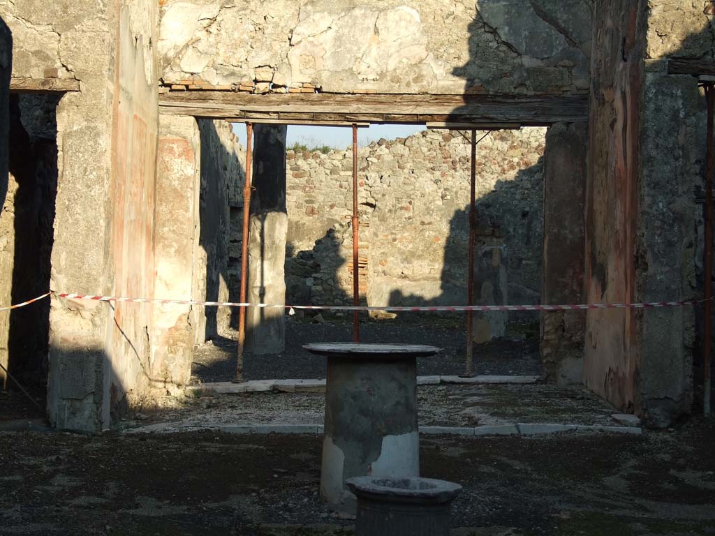 VI.14.40 Pompeii. December 2007. Peristyle on east side of tablinum.  
According to Jashemski, the peristyle garden at the rear of the tablinum, was visible from the entrance doorway. It was enclosed on most of the north and part of the south sides by narrow passageways. On the west side by a wide portico supported by two stuccoed columns, yellow to a height of I.86m, red above. The side passages were covered by overhanging roofs from the adjacent rooms. The triclinium on the left had a large window looking into the garden. On the right of the garden, a statuette of a small boy holding a little dog, was found. The front legs of the dog were missing, as were also the legs of the boy from the knees down. A rectangular base with a portion of the feet was found.
Now in Naples Archaeological Museum, inventory number 120511.
See Jashemski, W. F., 1993. The Gardens of Pompeii, Volume II: Appendices. New York: Caratzas. (p.151)
 