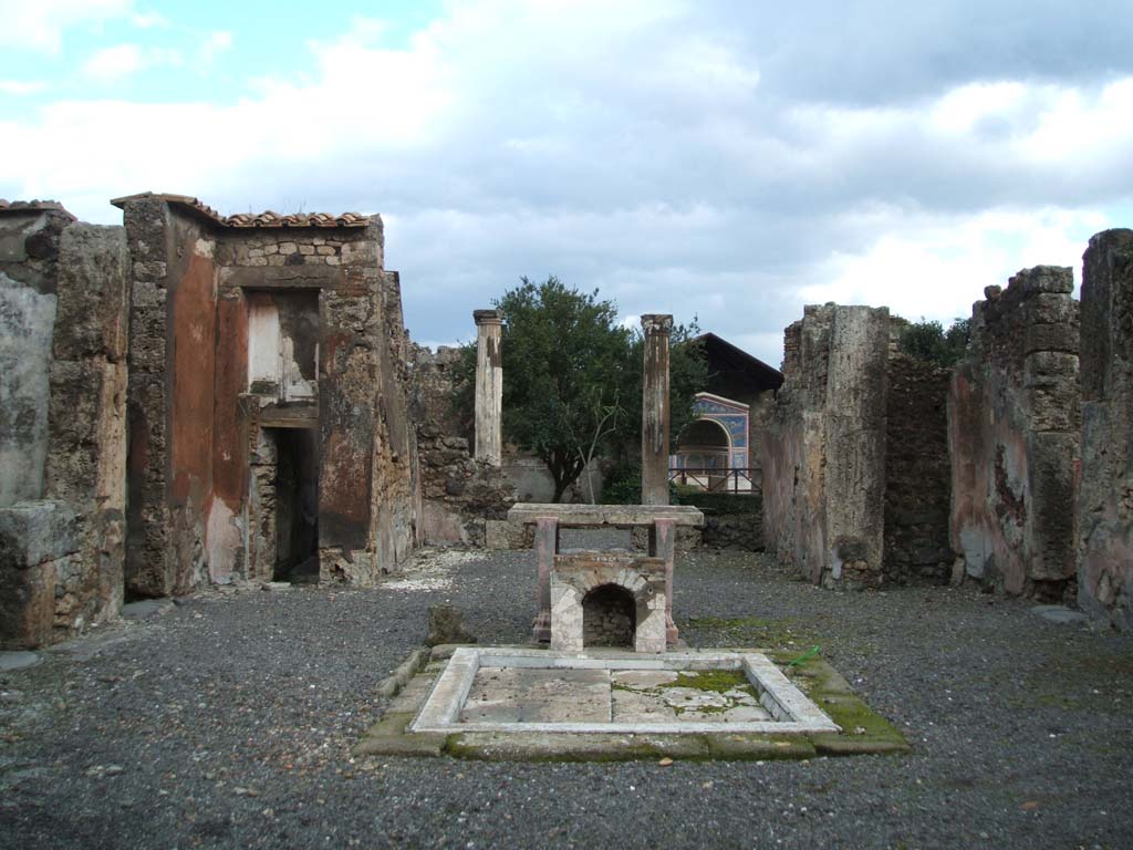 VI.14.43 Pompeii. October 2001. Room 1, looking east across impluvium in atrium, towards tablinum, and garden area. Photo courtesy of Peter Woods.
