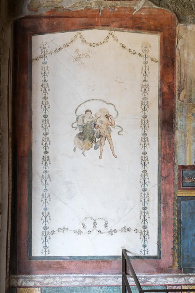 VI.15.1 Pompeii. May 2017. Painted panel of naval scene with basket and mask above, from west side of central painting on north wall of exedra. Photo courtesy of Buzz Ferebee.

