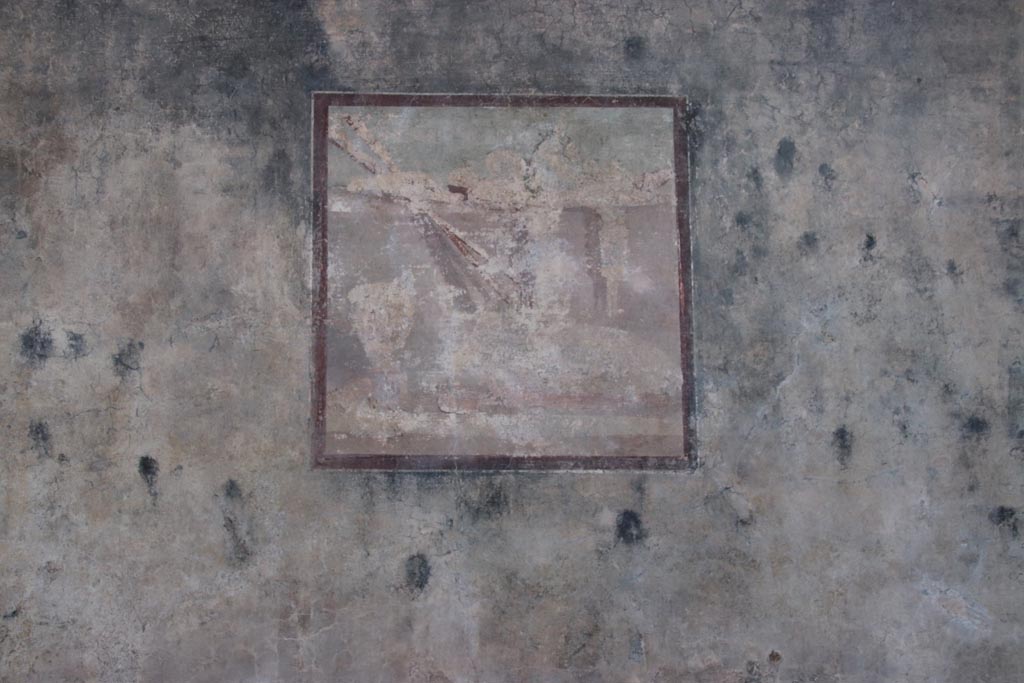 VI.15.1 Pompeii. October 2023. Central painting in panel on west wall of peristyle. Photo courtesy of Klaus Heese.
