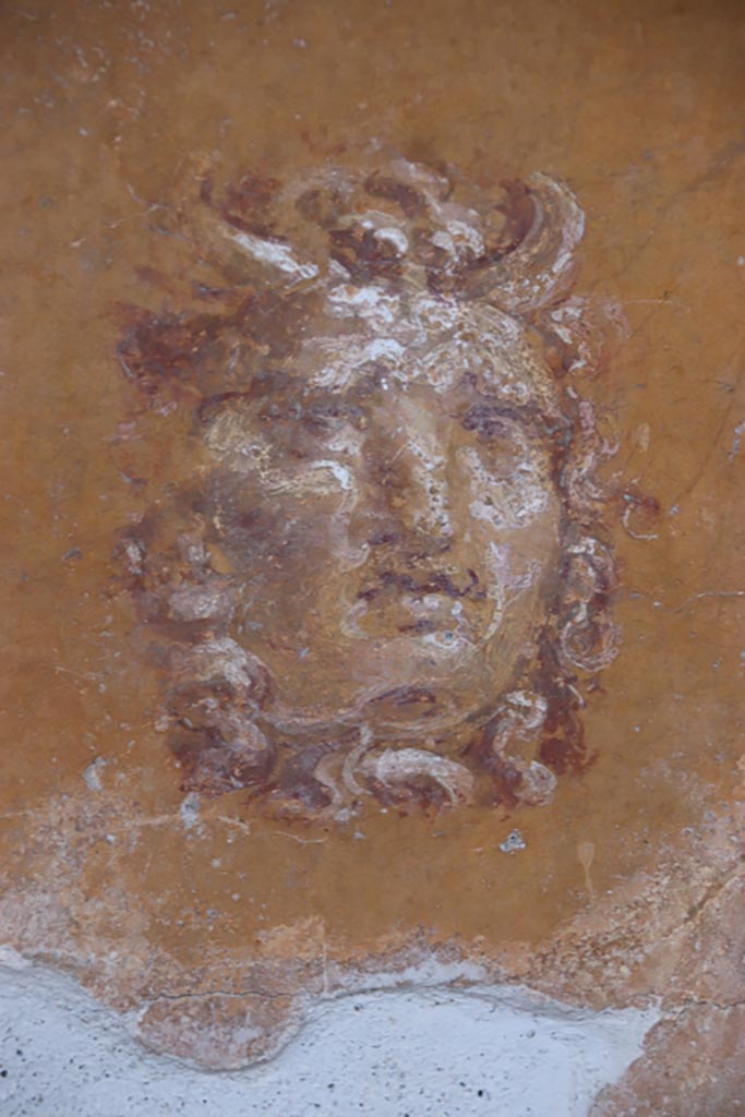 VI.15.1 Pompeii. October 2023. Detail from west wall of peristyle. Photo courtesy of Klaus Heese.
