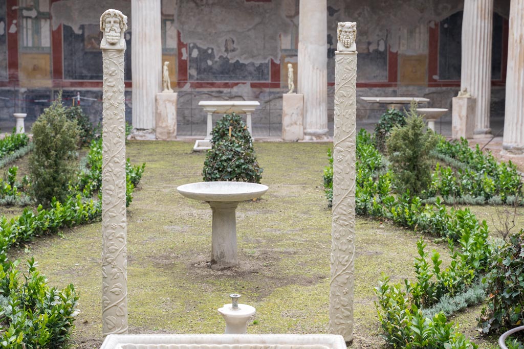 VI.15.1 Pompeii. March 2023. Looking south across peristyle garden towards the two marble herms. Photo courtesy of Johannes Eber.