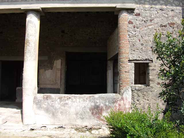 VI.15.8 Pompeii. May 2010. Looking east from garden to portico and doorways to oecus and doorway and window of summer triclinium.