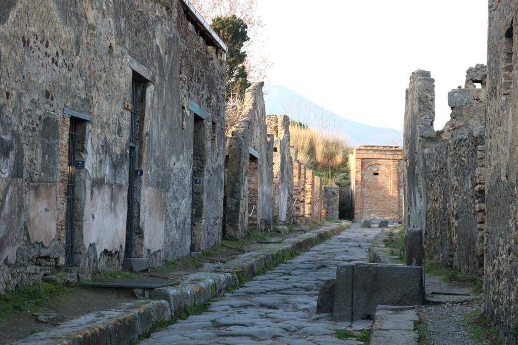Vicolo dei Vettii, west side, between VI.15 and VI.16. December 2018. 
Looking north from VI.15.7, on left, towards VI.15.18, in centre near water tower. Photo courtesy of Aude Durand

