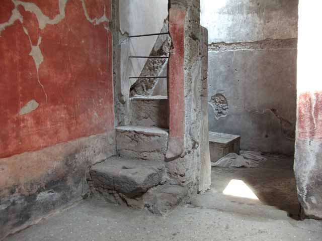 VI.15.8 Pompeii. May 2010. Room to north of entrance with stone steps and site of line of staircase in the plasterwork on the north wall.