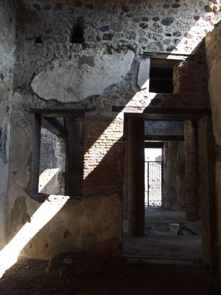 VI.15.9 Pompeii. March 2009. East wall of triclinium, with doorway and window to atrium. Looking east to front entrance across atrium.

