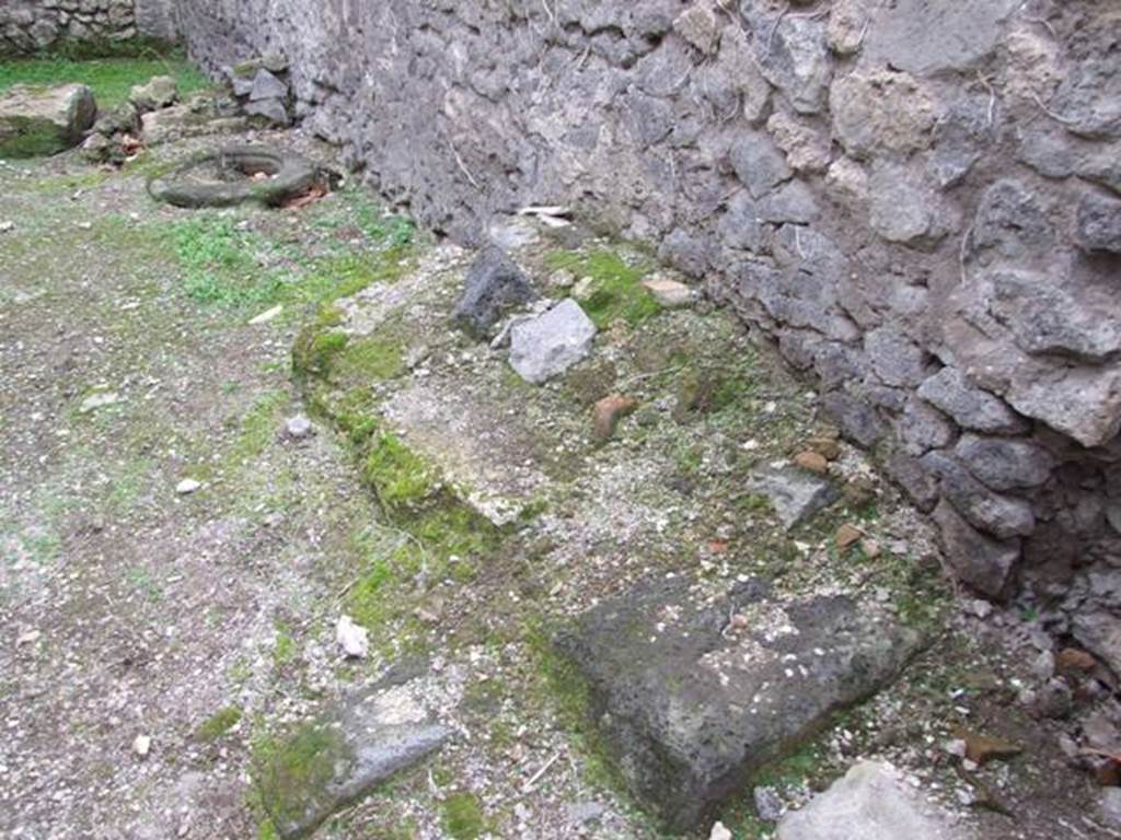 VI.16.5 Pompeii. December 2007. Remains of masonry base and staircase against north wall.