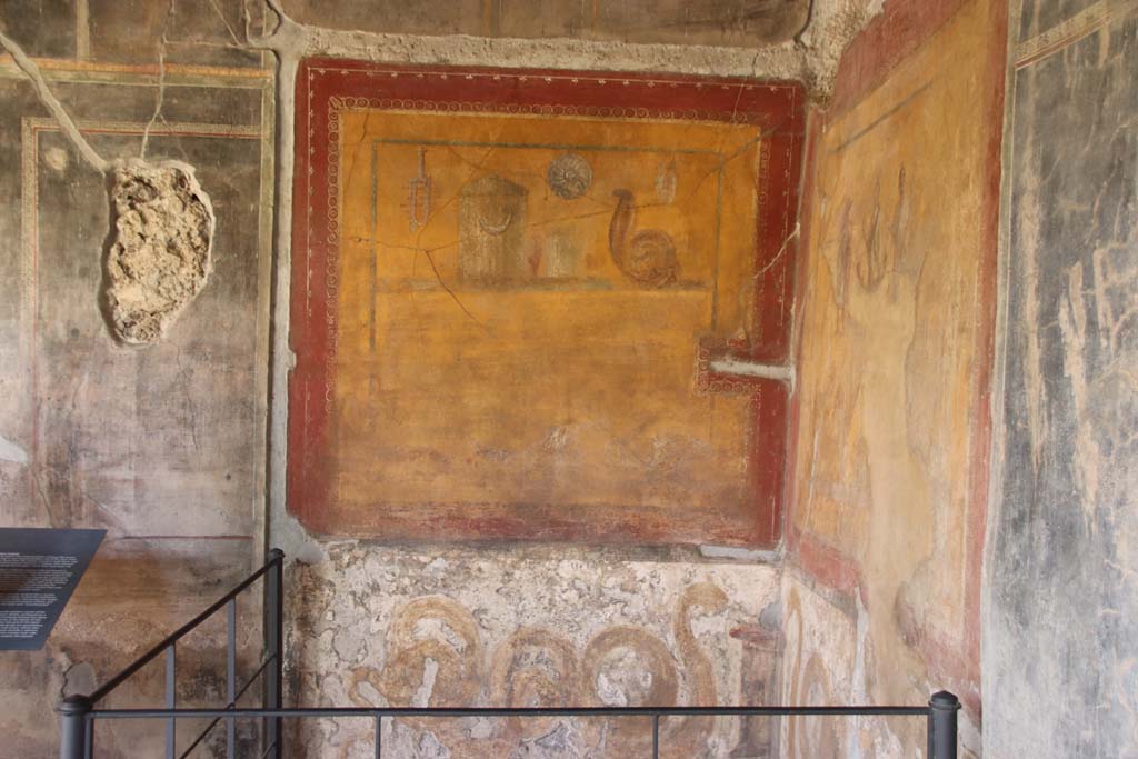 VI.16.7 Pompeii. May 2006. Room F, lararium in south-east corner of peristyle.   According to Boyce, in the south-east corner is a shrine dedicated to the cult of the Egyptian deities. On each wall a large yellow panel is marked off by a broad red border. See Boyce G. K., 1937. Corpus of the Lararia of Pompeii. Rome: MAAR 14. (p.56, no.220)
