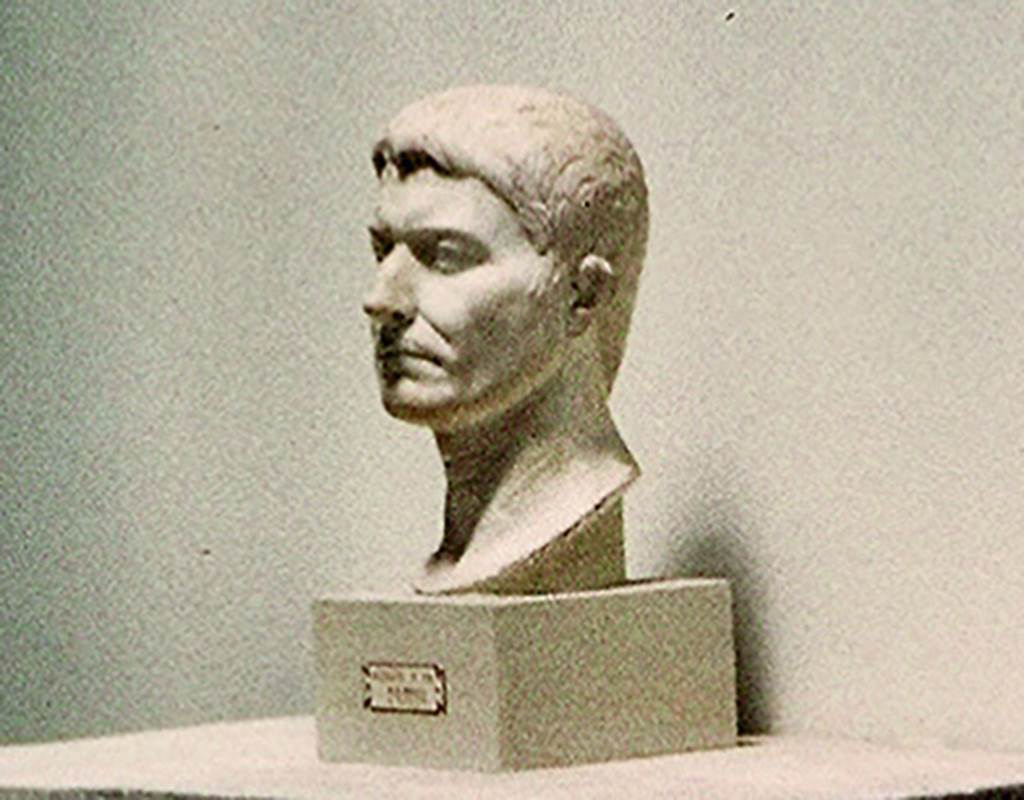 VI.16.7 Pompeii. On display in Antiquarium in August 1965. Portrait bust of an unknown male, still of young age. In the base is an iron pin, indicating that it once stood on a pilaster.
Found in the third gap in the columns of the southern portico, starting from the south-west corner.
According to PPM, the style of the portrait indicates the late-Tiberian era.
SAP inventory number 55514 or 3015. Photo courtesy of Rick Bauer.
See Notizie degli Scavi di Antichità, 1907, p. 593; fig. 41.
See Carratelli, G. P., 1990-2003. Pompei: Pitture e Mosaici: Vol. V.  Roma: Istituto della enciclopedia italiana, p. 746. 

