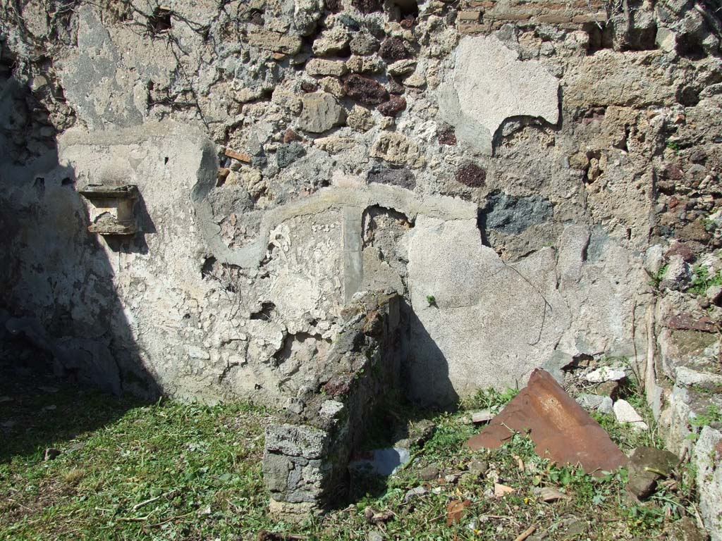VI.16.12 Pompeii. March 2009. Looking west into rear-room on north-west side behind shop room. According to NdS, the rear room had flooring of opus signinum, and the walls were of rough plaster. The room received light from a window in the west wall, with wooden windowsill and jambs.

