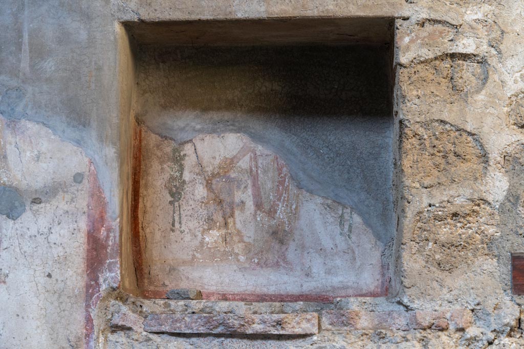 VI.16.15 Pompeii. January 2024. Niche of lararium on north wall of atrium, with remains of painting. Photo courtesy of Johannes Eber.