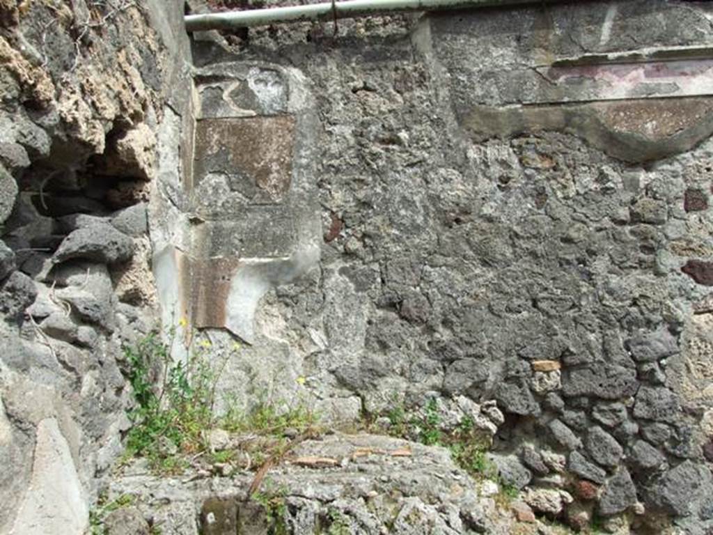 VI.16.27 Pompeii. March 2009.  Room F, remains of decoration and painted plaster on east wal labove staircase.
