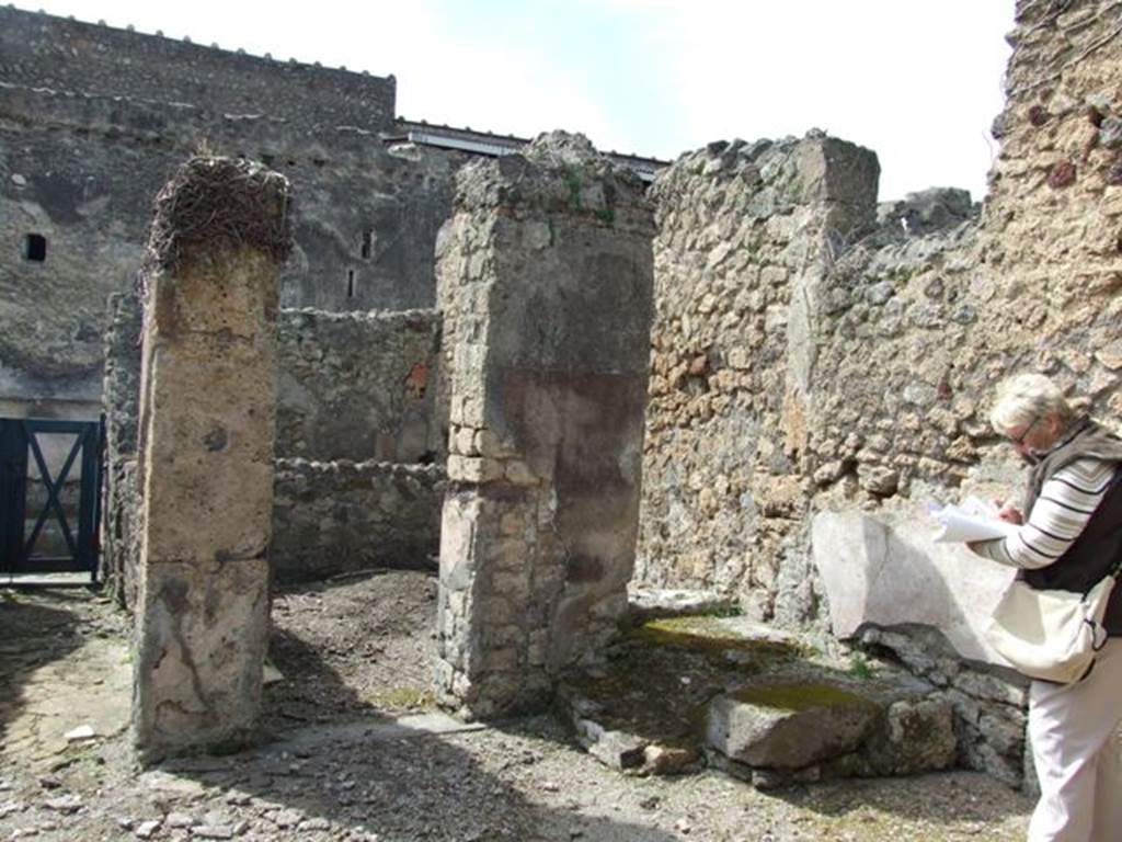 VI.16.28 Pompeii. March 2009.  North-west corner of room C, atrium, with doorway to room E, room with stairs (d). According to NdS, in the north-west corner of the atrium was the beginning of a masonry step, for a wooden staircase.
