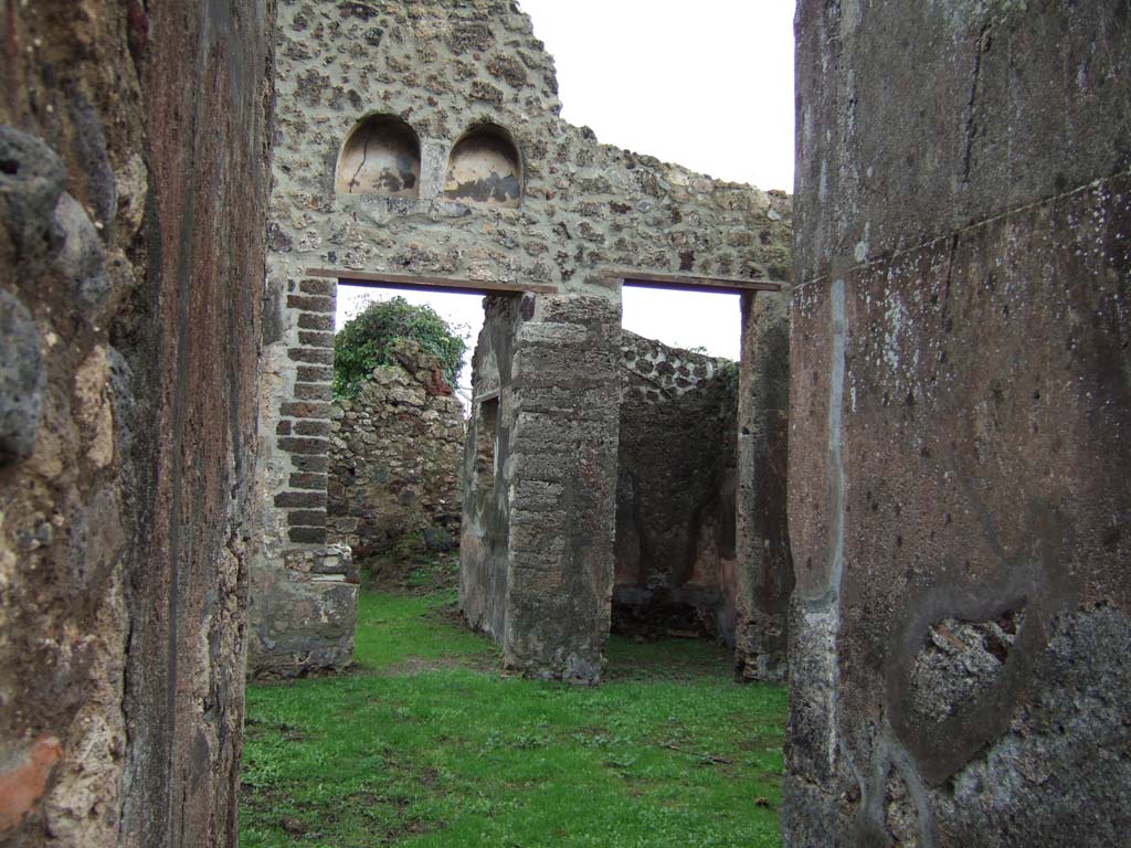 VI.16.32 Pompeii. December 2005. Room B, looking across atrium towards doorways to rooms F and H, from fauces A.
